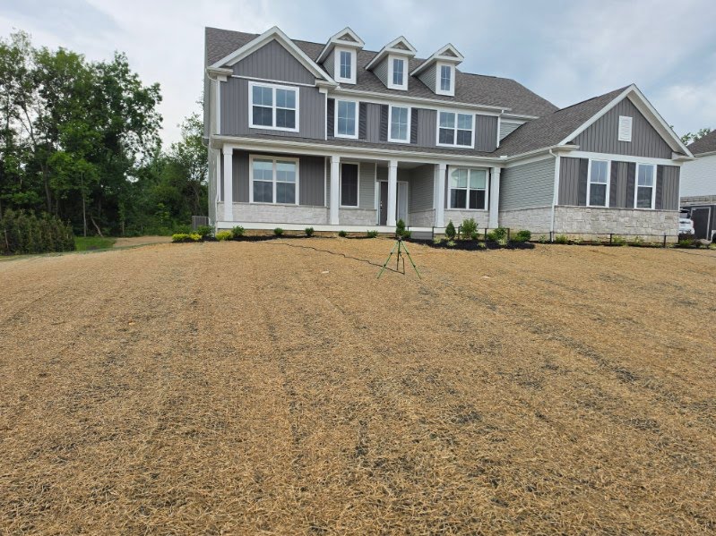 Front yard freshly seeded and covered in straw at a new home